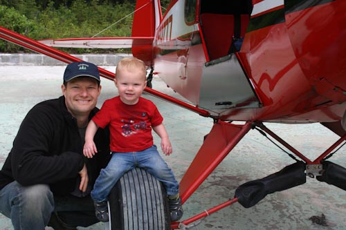 Grant and Aaron on the wheel of a Super Cub Airplane in Alaska